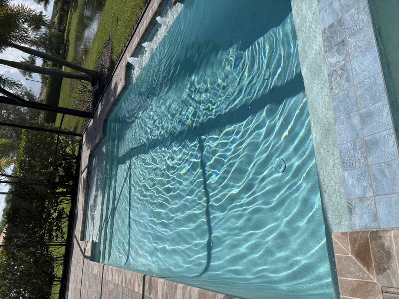 Clean residential pool after weekly service